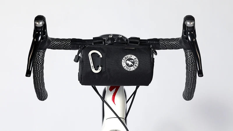 Handlebar bag attached to a road bike with a white background