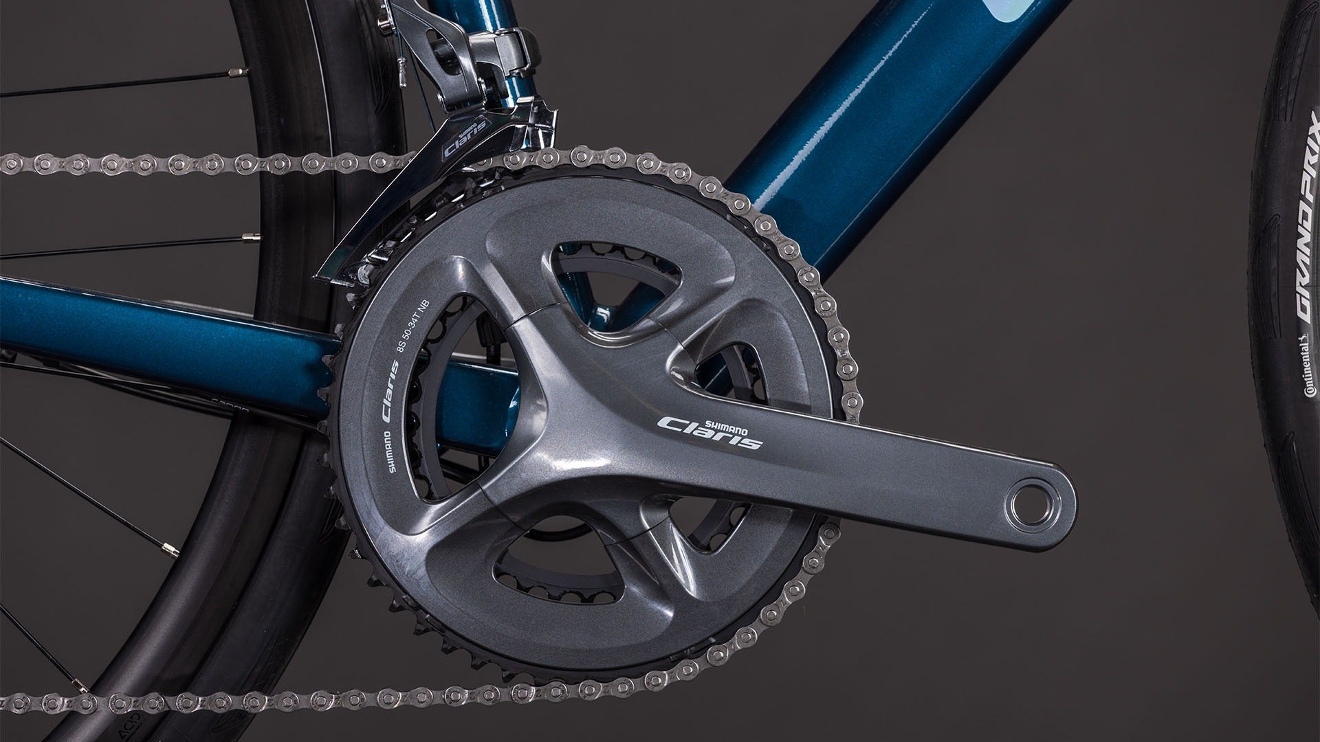 Close-up of a road bike chain and gear system on a dark background