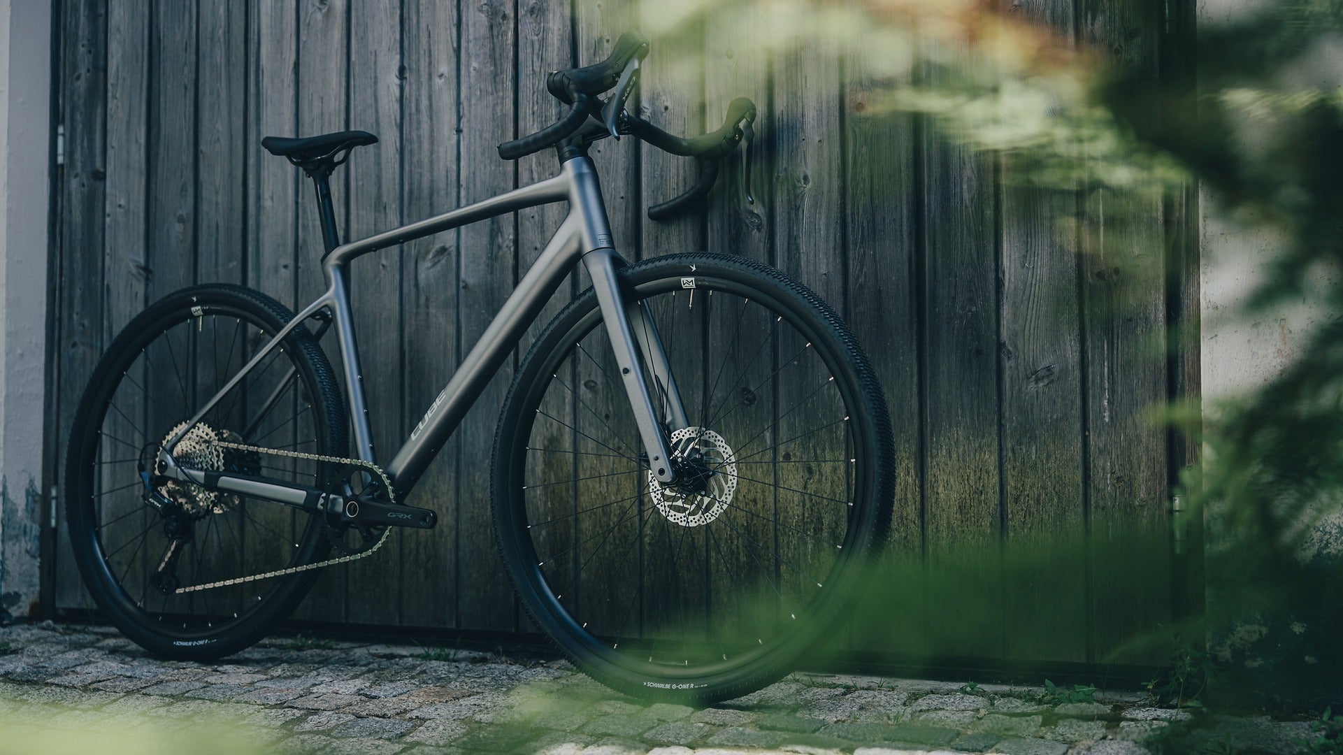Cube Gravel Bike leaning against a wooden fence