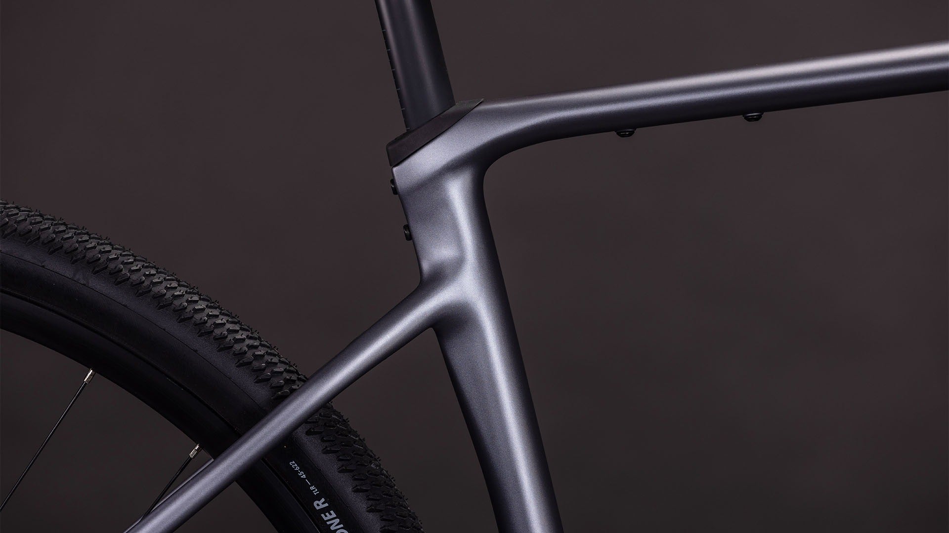 Close-up of the seat tube of a bicycle frame with a dark background