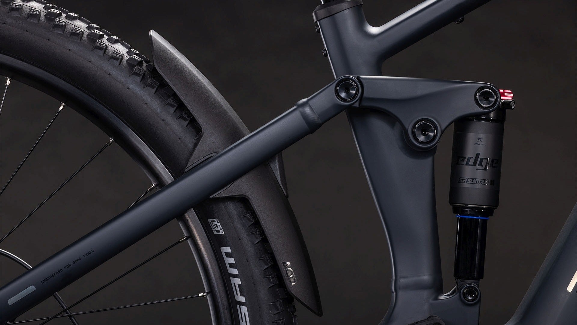 Close-up of a mountain bike rear suspension on a dark background