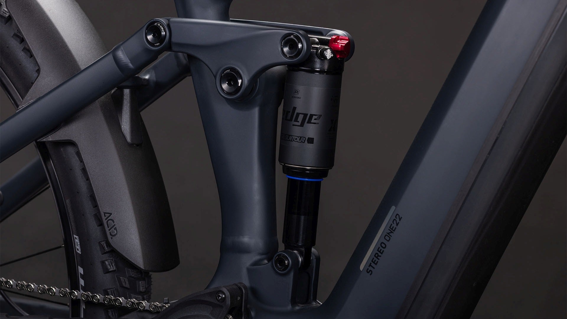 Close-up of the rear suspension on an electric mountain bike on a dark background