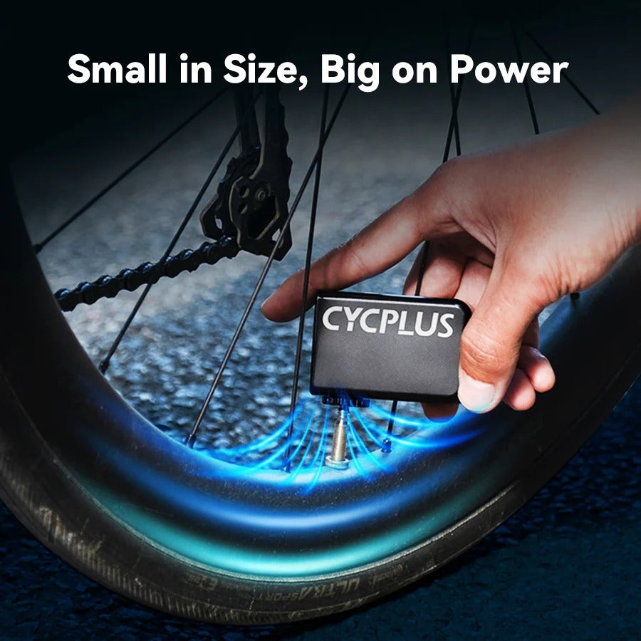 A picture of a mini bike pump compressor inflating a tyre