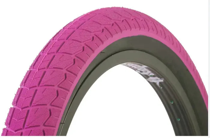 Close-up of a BMX Bike pink tyre with tread pattern on a white background