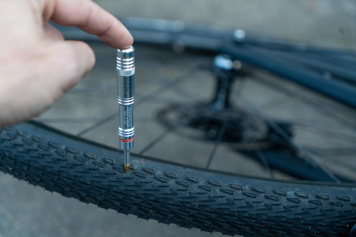 A picture of someone using the Dynaplug Racer Pro Tubeless Repair Kit to repair a puncture