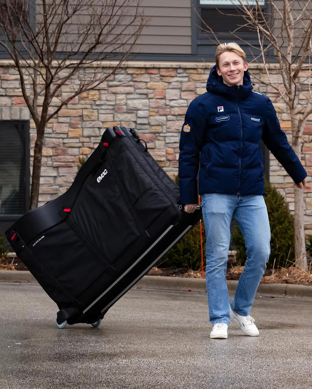 A picture of a guy pulling the Evoc Pro Bike Bag along