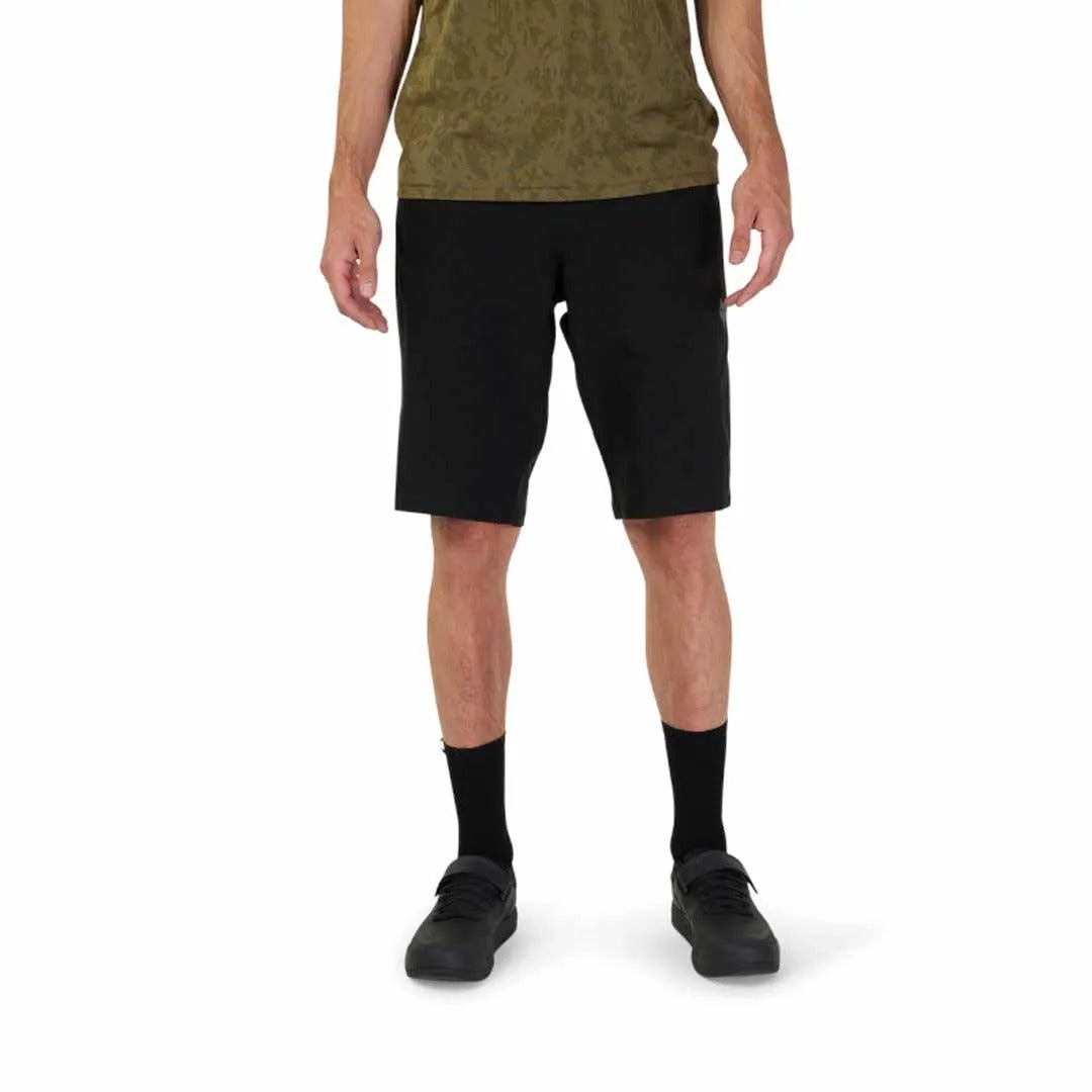 Person wearing black mountain bike shorts on a white background