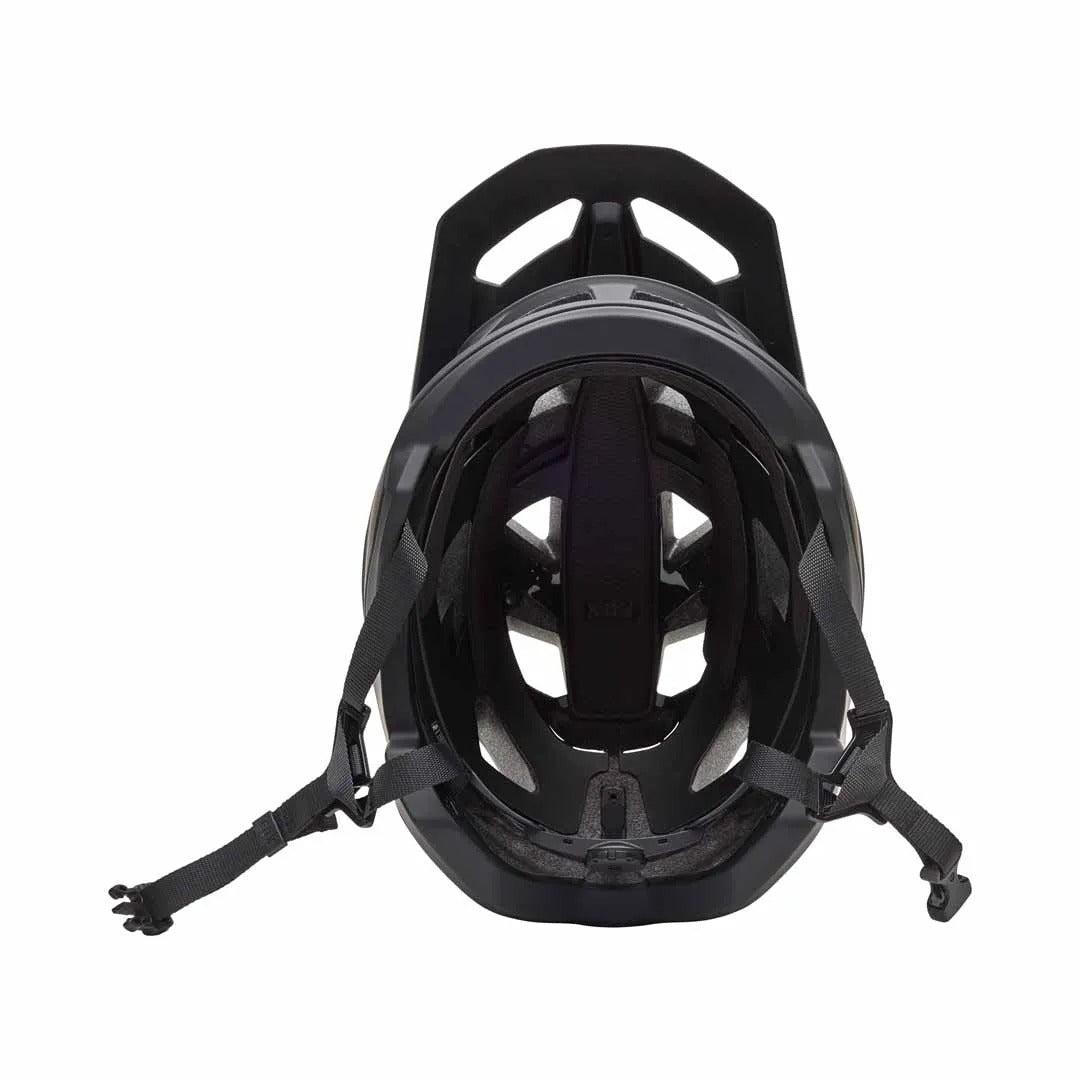 An inside view of a black mountain bike helmet on a white background
