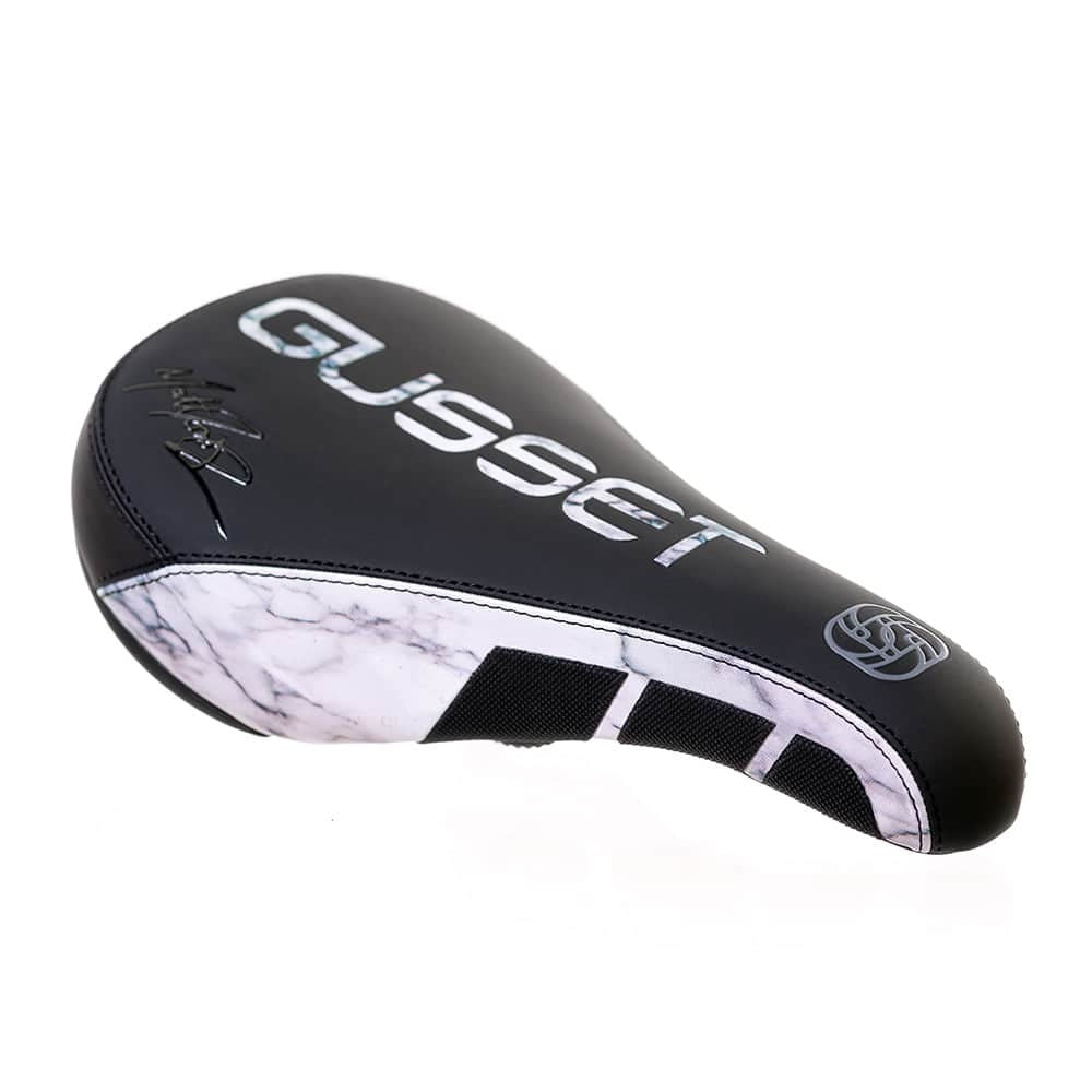 Black and white bicycle seat with 'Gusset' branding on a white background