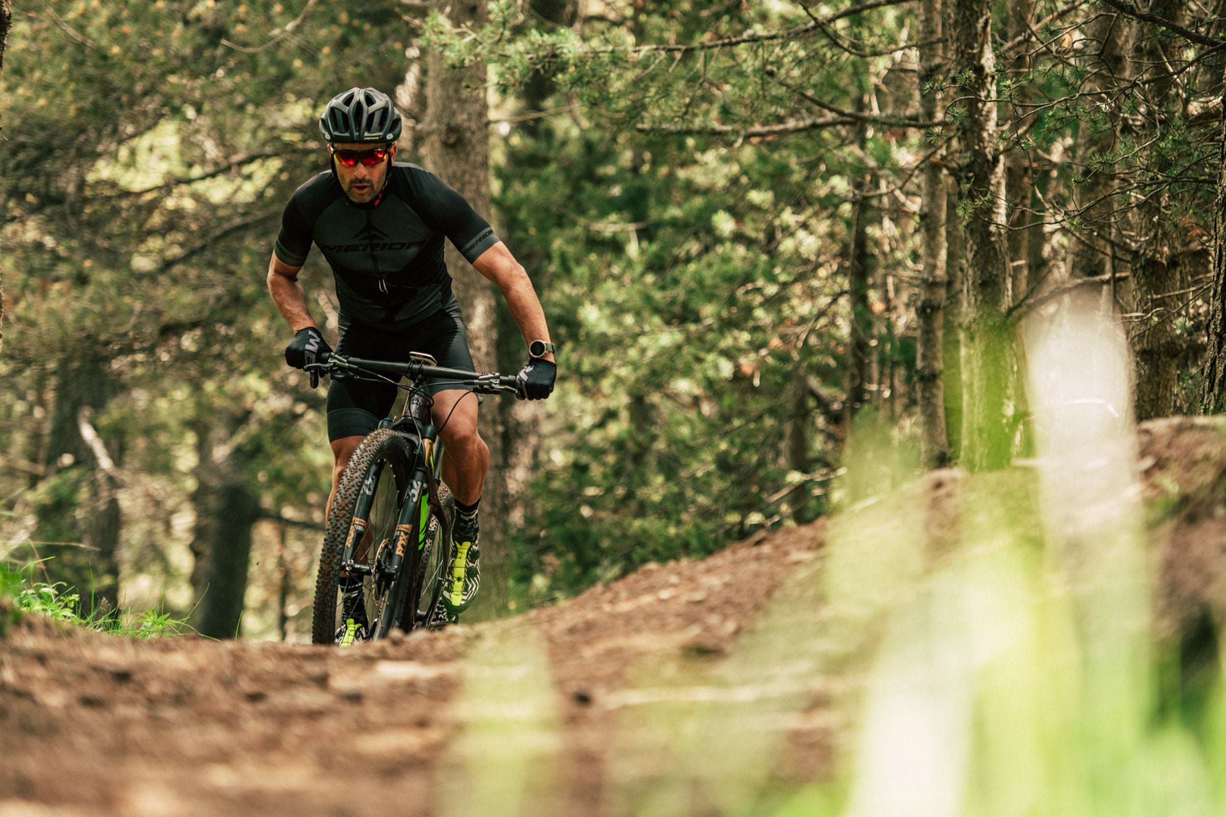 A picture of someone standing in the saddle on a Merida mountain bike