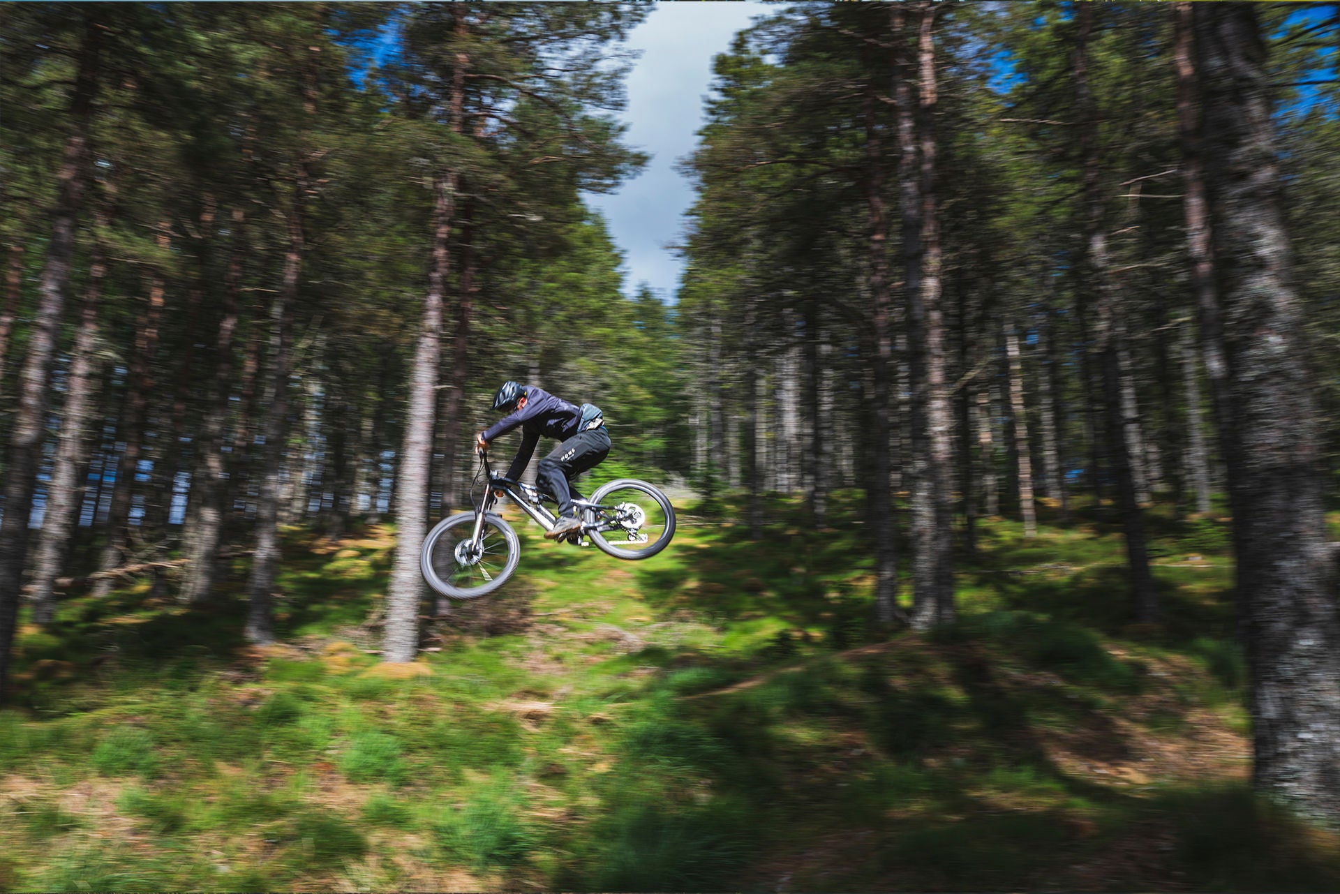 A picture of someone jumping on a Merida Dual Suspension Mountain Bike