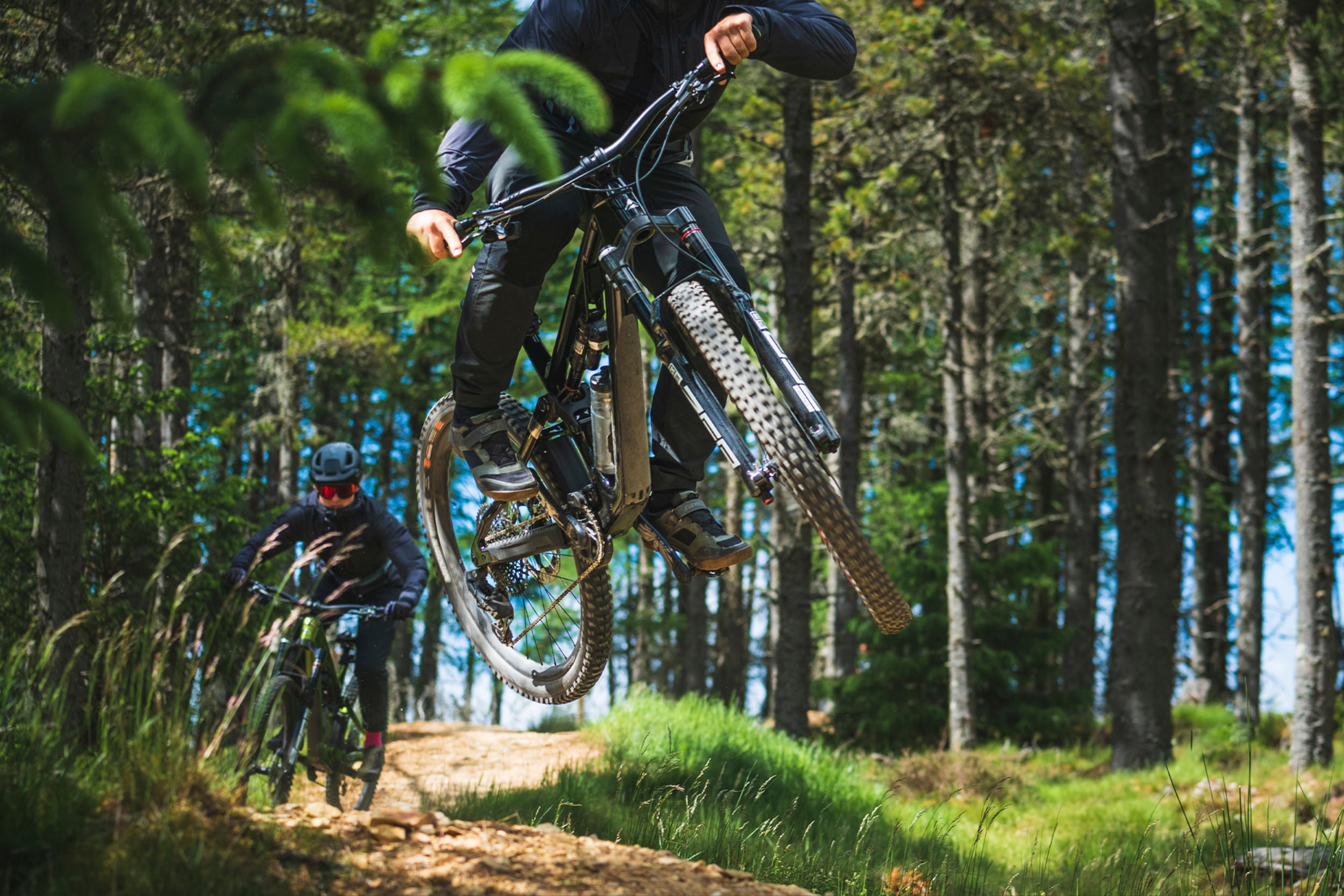 A picture of two people riding offroad on Merida Mountain Bikes