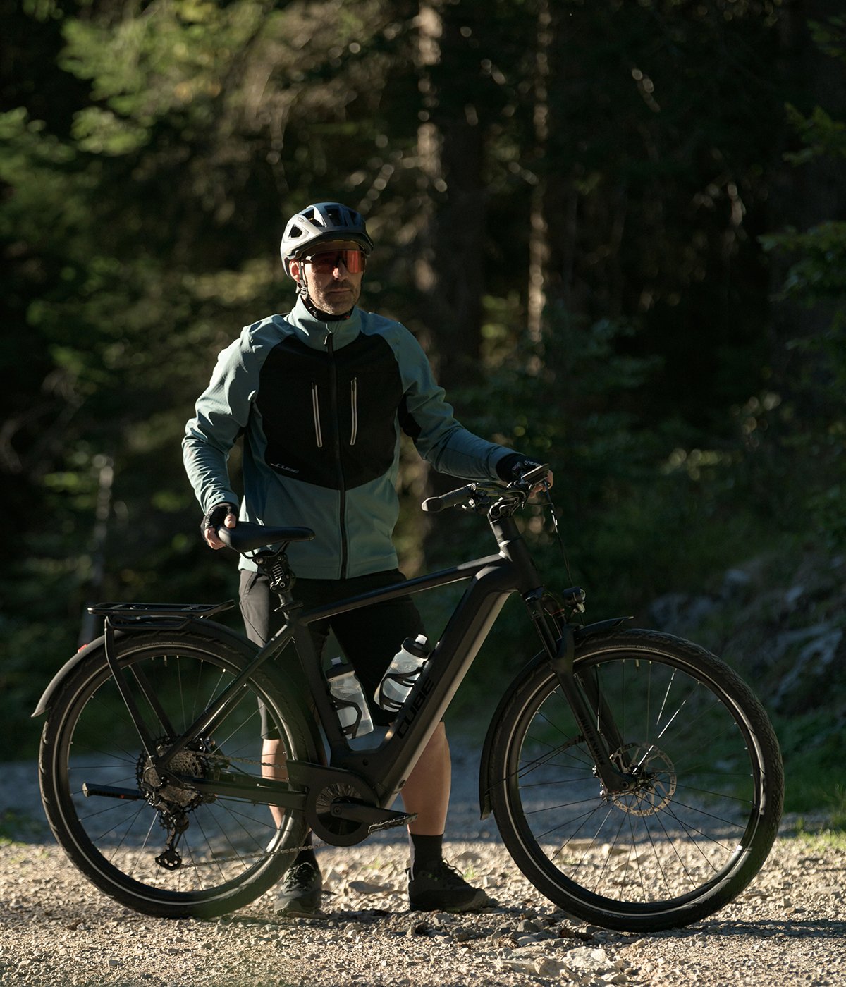 A picture of somone standing holding the Cube Reaction Hybrid Performance 500 Electric Hardtail Bike