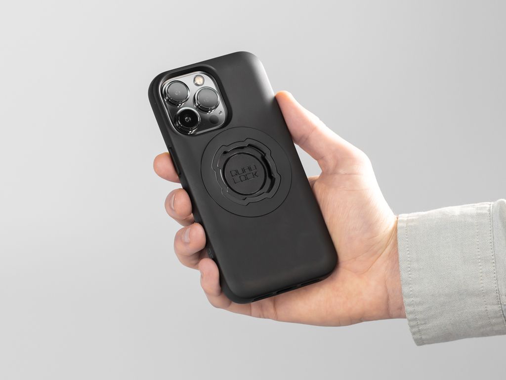 A picture of someone holding a phone with a Quad Lock Case on it