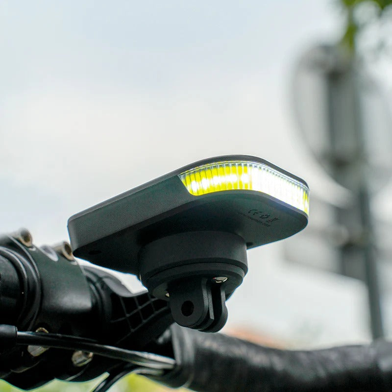 Bicycle light attached to handlebars with a blurred background