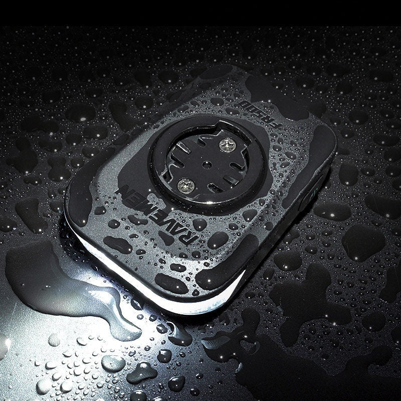 Ravemen FR500 Front Bicycle Light covered in water droplets on a black background
