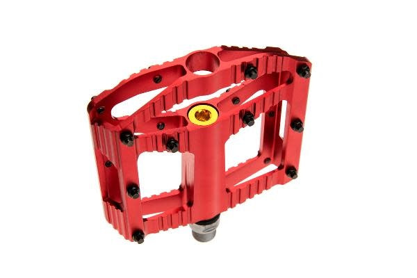 Red Mountain Bike Pedal with black pins on a white background