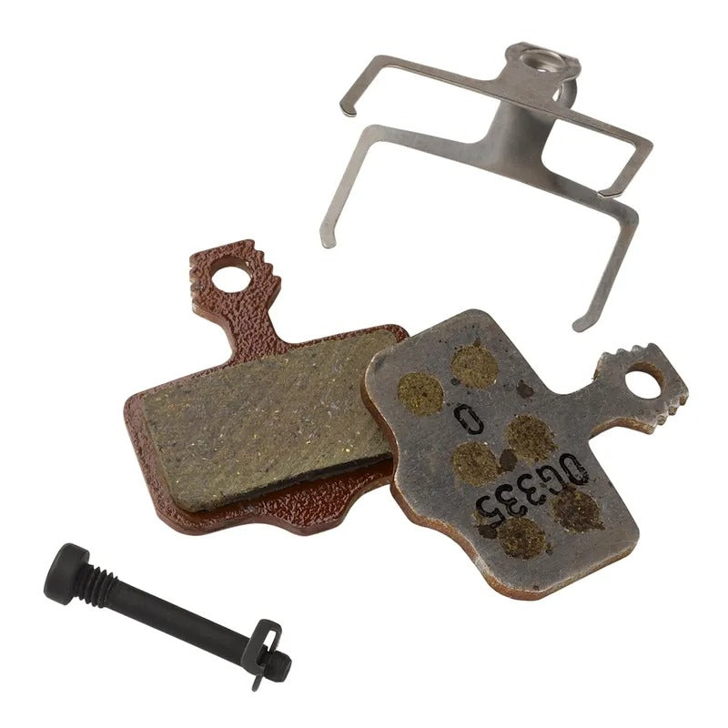 Brake pad set with metal bracket and screw on a white background