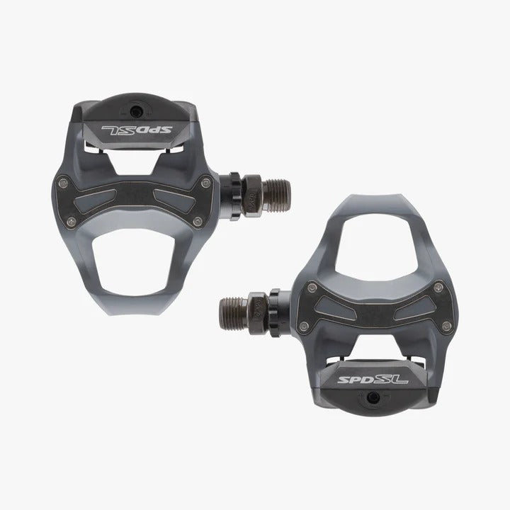 Pair of black road cycling pedals with 'SPD SL' branding on a white background