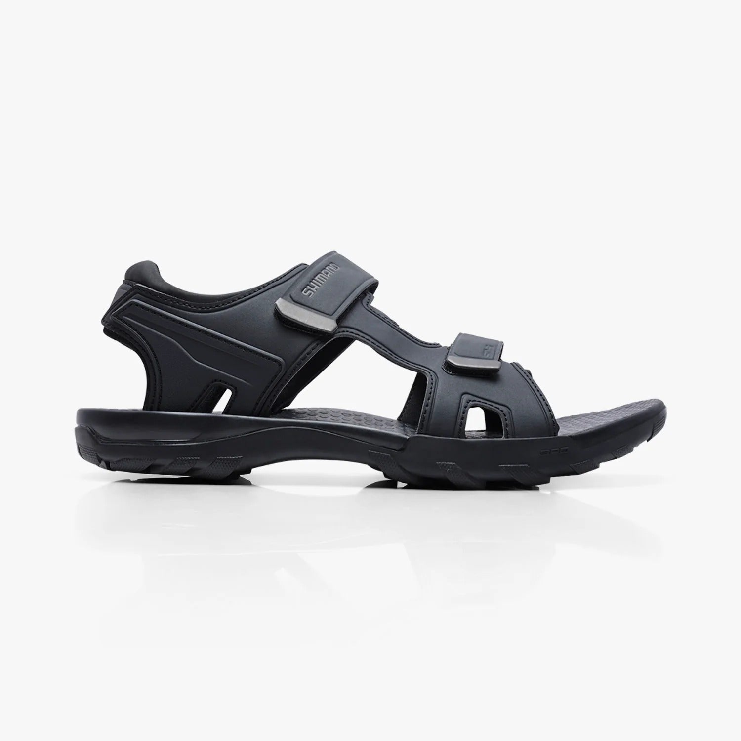 Black cycling sandal with a strap on a white background