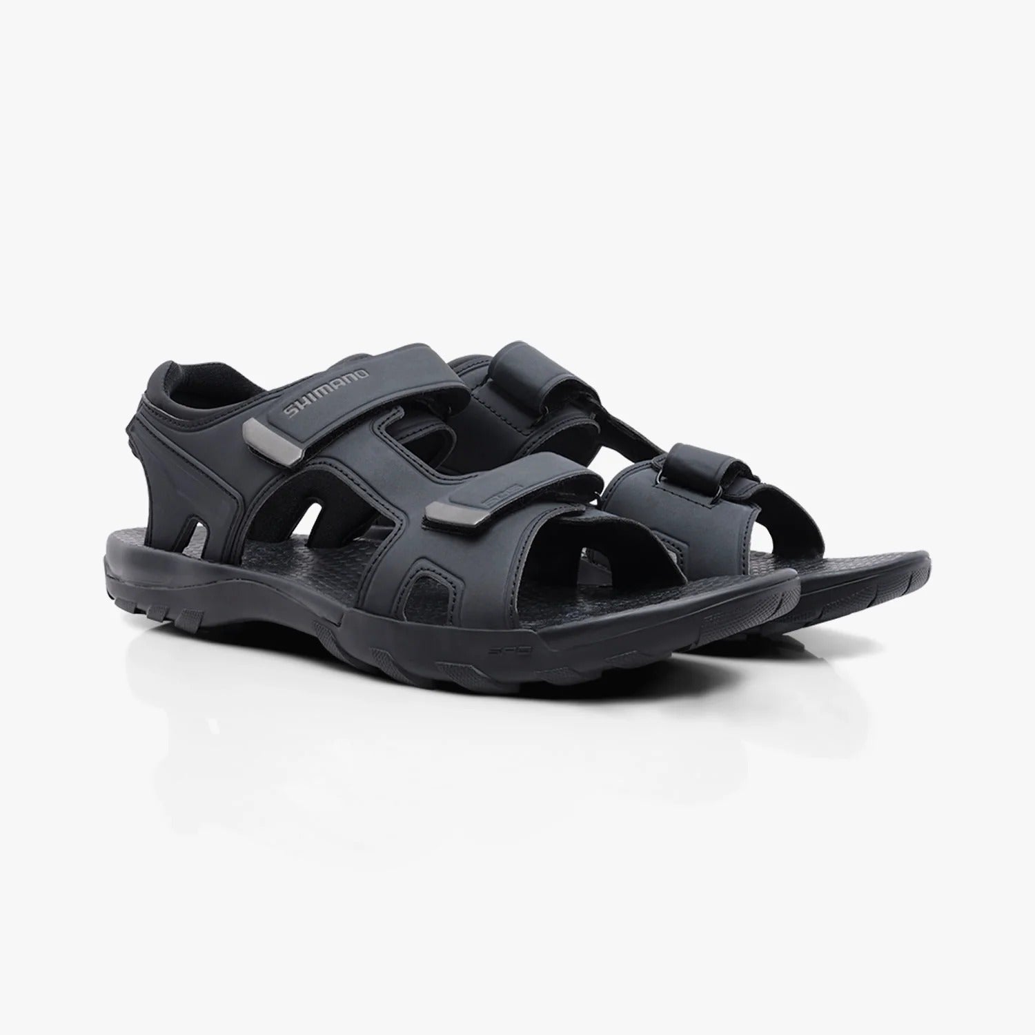 Black Shimano cycling sandals with multiple straps on a white background