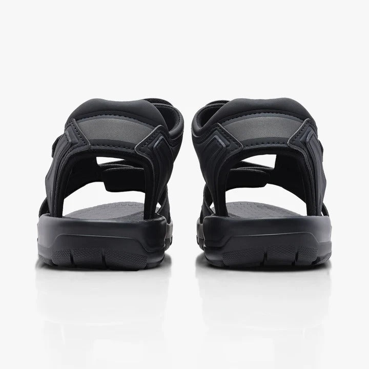 Pair of blackcycling sandals shown from the back on a white background
