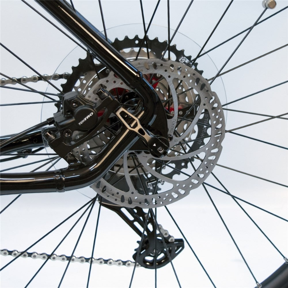 Close-up of a bicycle's rear brake rotor with a white background