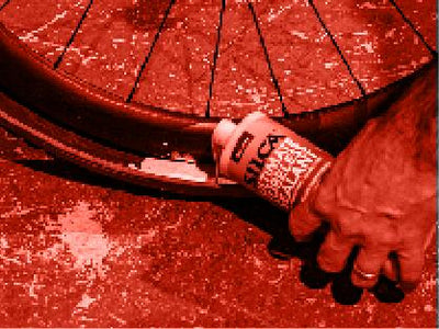 A picture of someone pouring Silca Ultimate Tubeless Sealant into a tyre