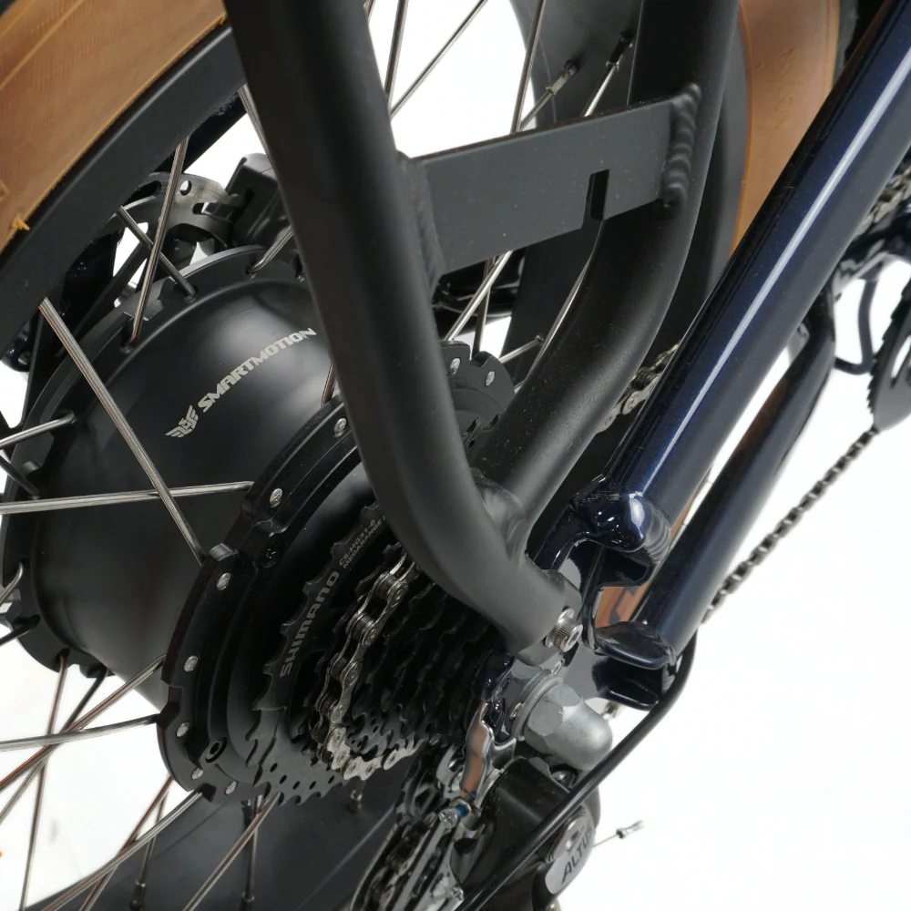 Close up of the rear cassette on a navy e-bike on a white background