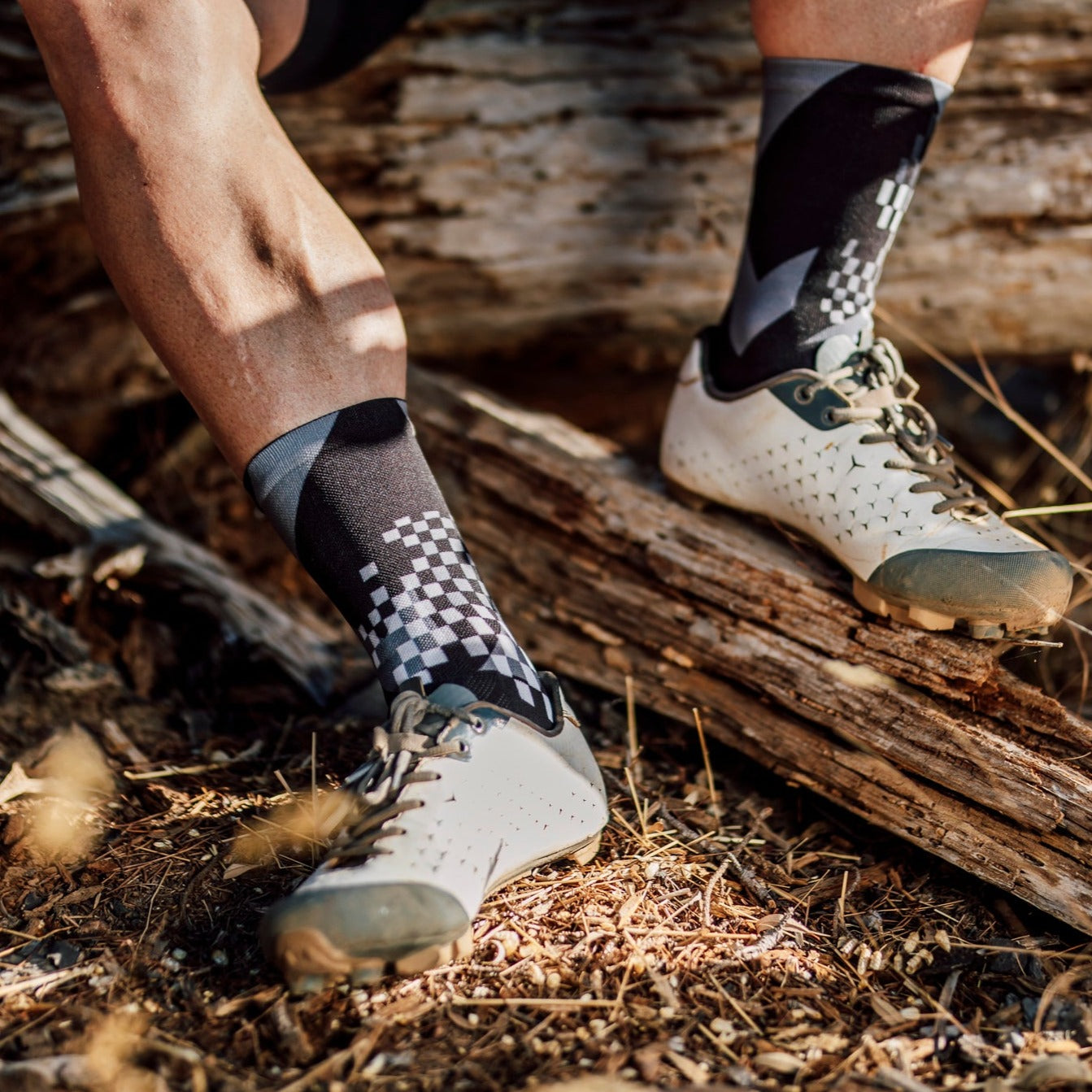 A picture of someone wearing the X Black Cycling Socks with mountain bike shoes