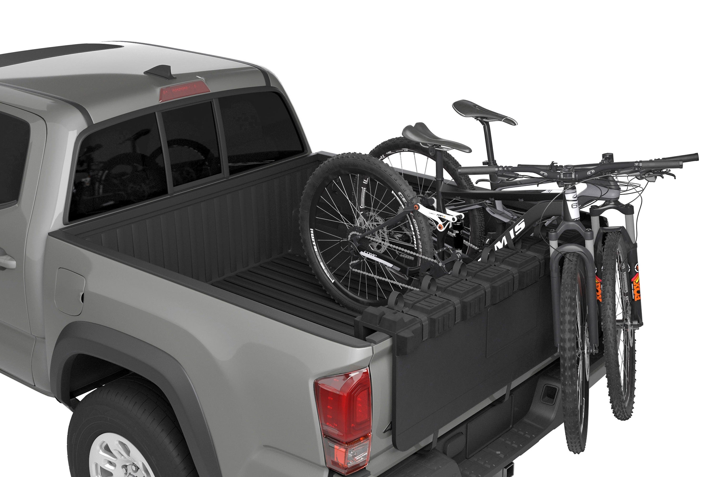 Gray pickup truck with a truck bed bike rack carrying two bicycles on a white background