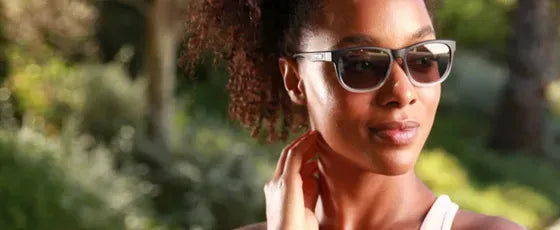 Woman wearing sunglasses with a blurred natural background