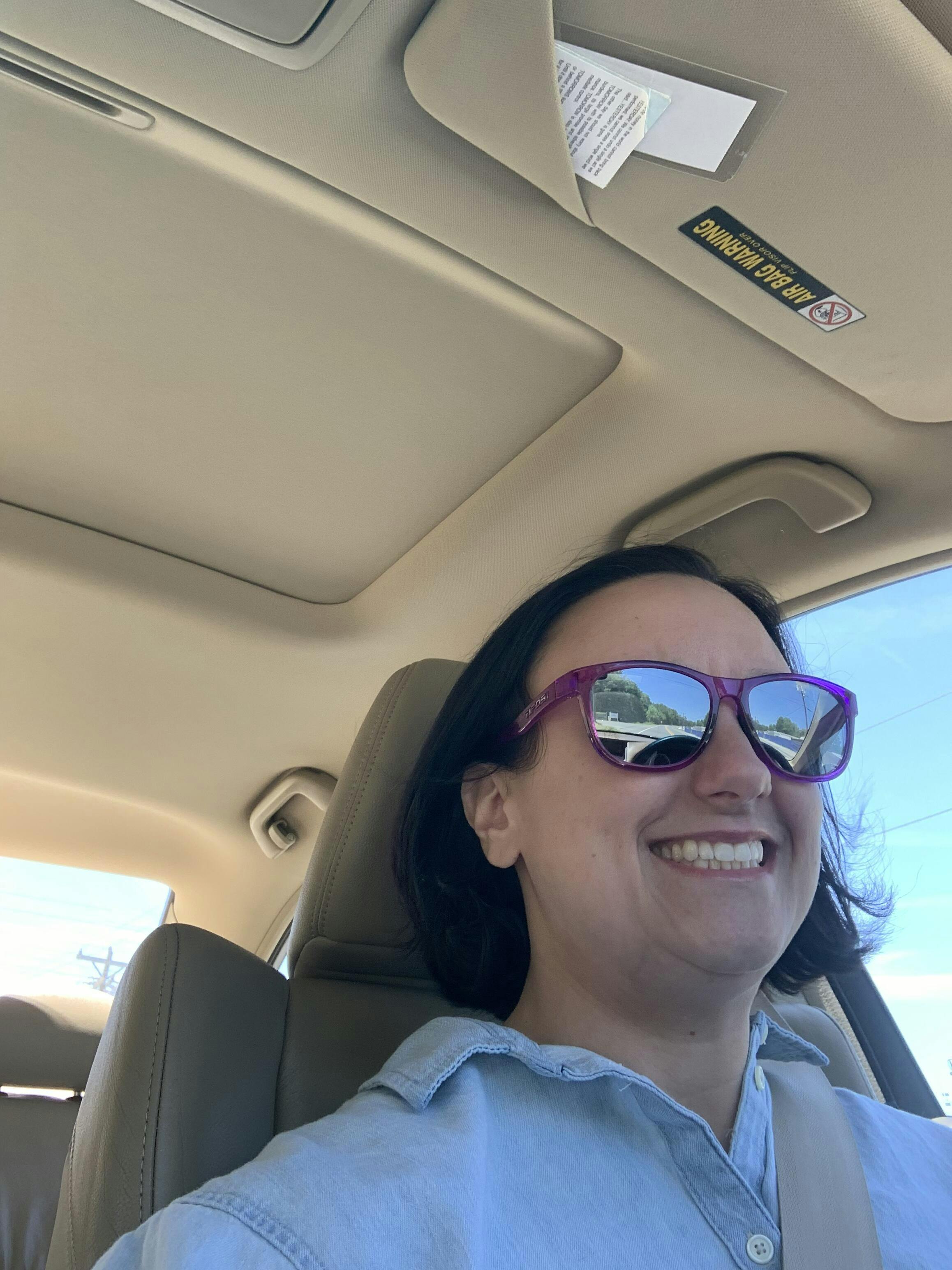 A picture of a lady driving a car wearing the Tifosi Swank Sunglasses