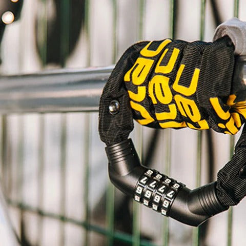 Black and yellow bike lock attached to a metal railing