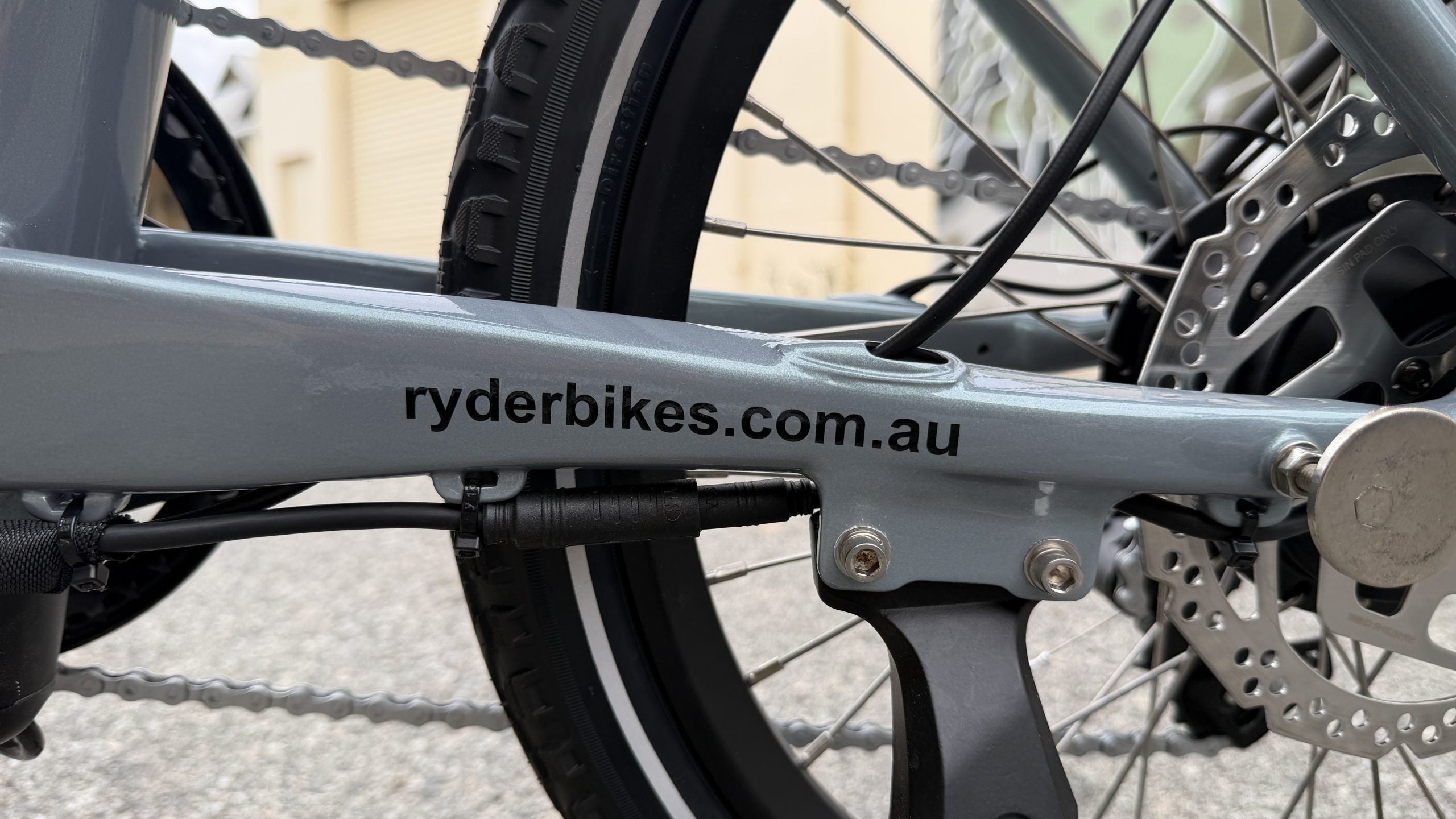 Close-up of a bicycle with 'ryderbikes.com.au' branding on the frame.