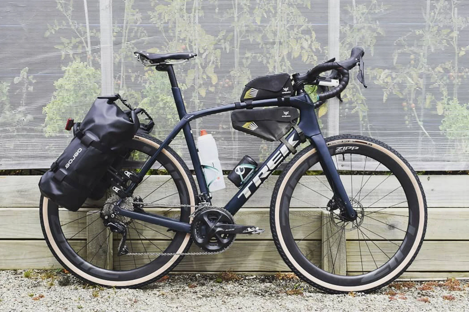 A picture of a gravel bike  the Aeroe Spider Rear bike rack and cradles with bags attached