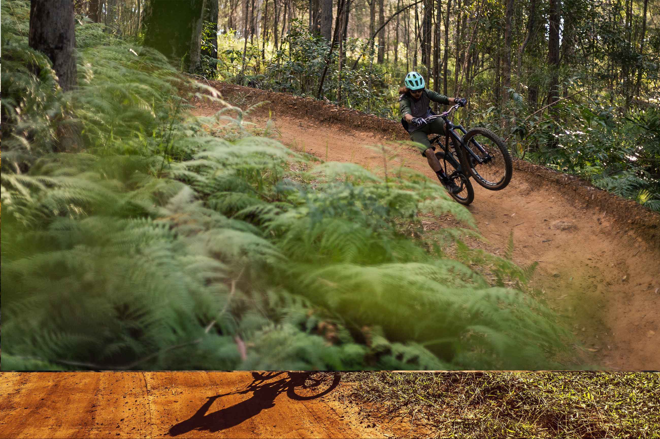 A picture of a guy doing a wheelie on mountain bike with Maxxis tyres on bike