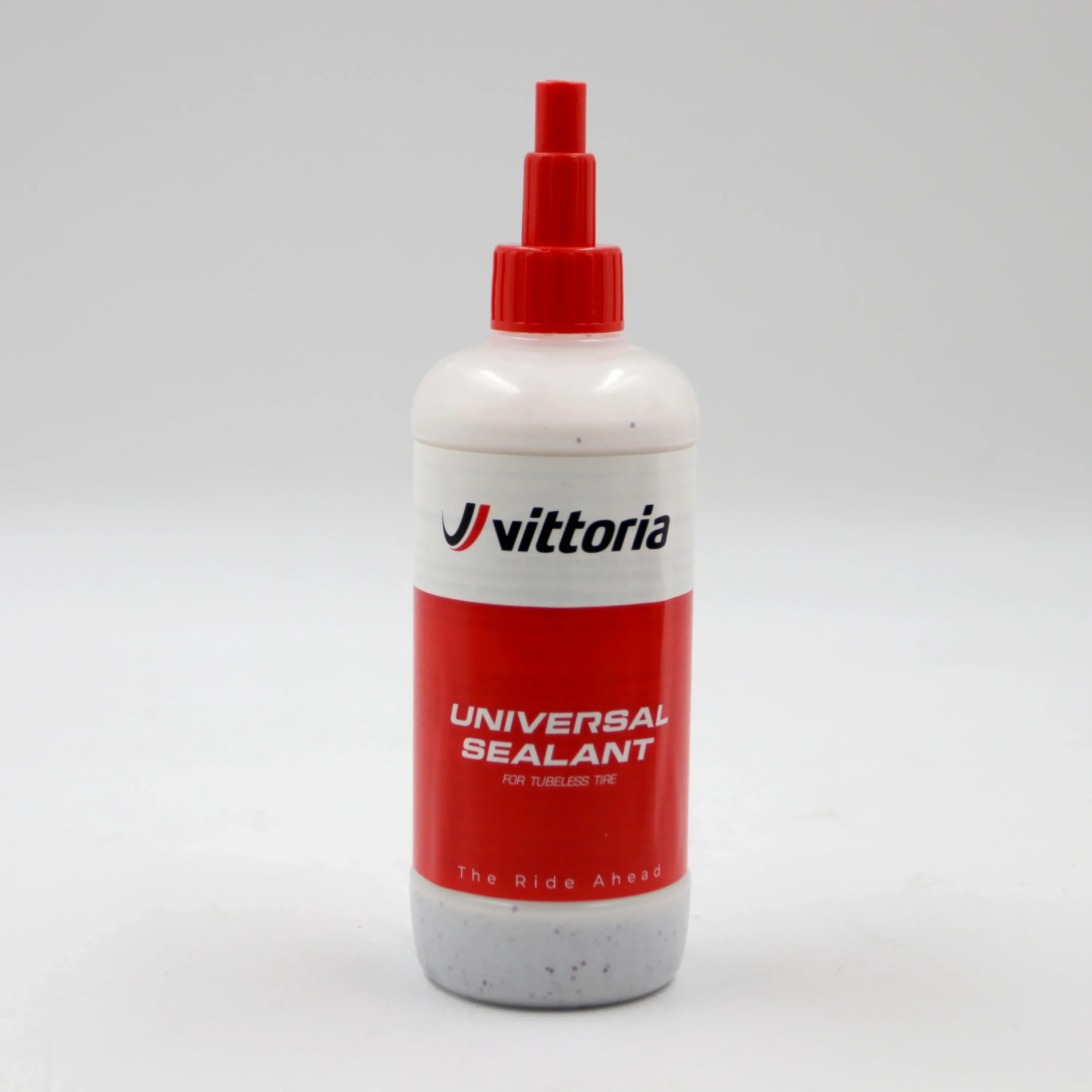 Vittoria universal sealant bottle with red cap on a white background