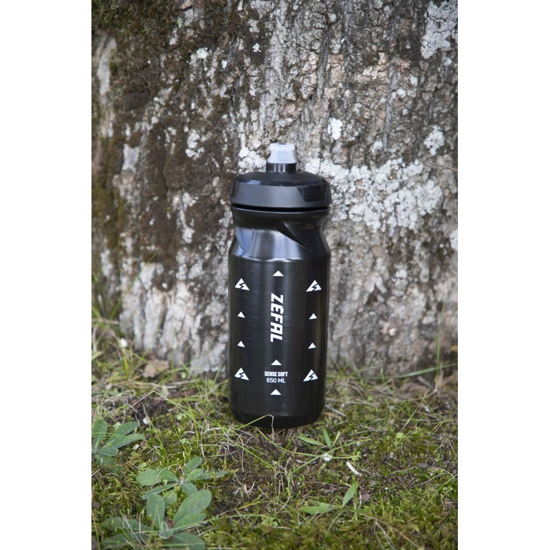 Black Zefal water bottle  against a tree trunk background