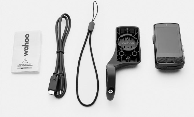 Wahoo fitness device with USB cable, lanyard, and packaging on a white background