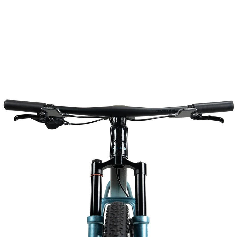 A front view of a black and blue X-LAB mountain bike showing the handlebar and part of the front fork on a white background