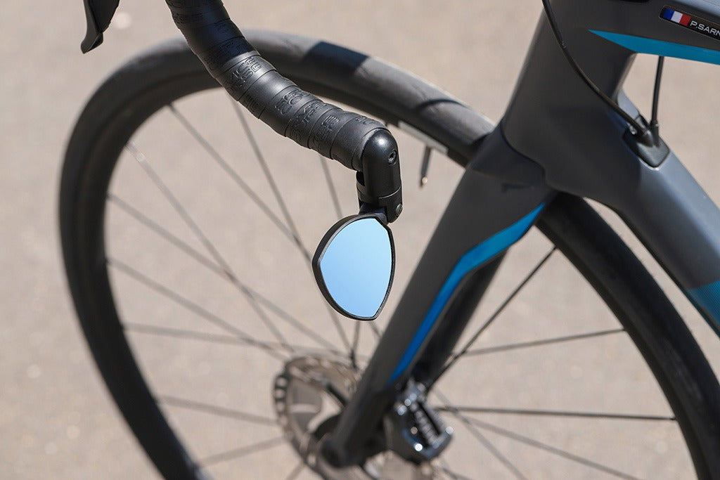 Road Bike handlebar with a small mirror attached on a blurred background