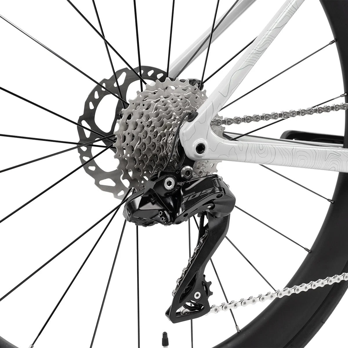 Close-up of a bicycle's rear wheel with gear and chain mechanism on a white background