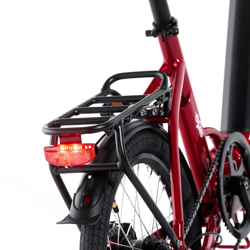 Red bicycle with a black rear rack and red light on a white background