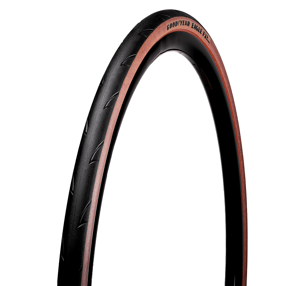 A Road Bike Tyre with tan wall and with Goodyear branding on a white background