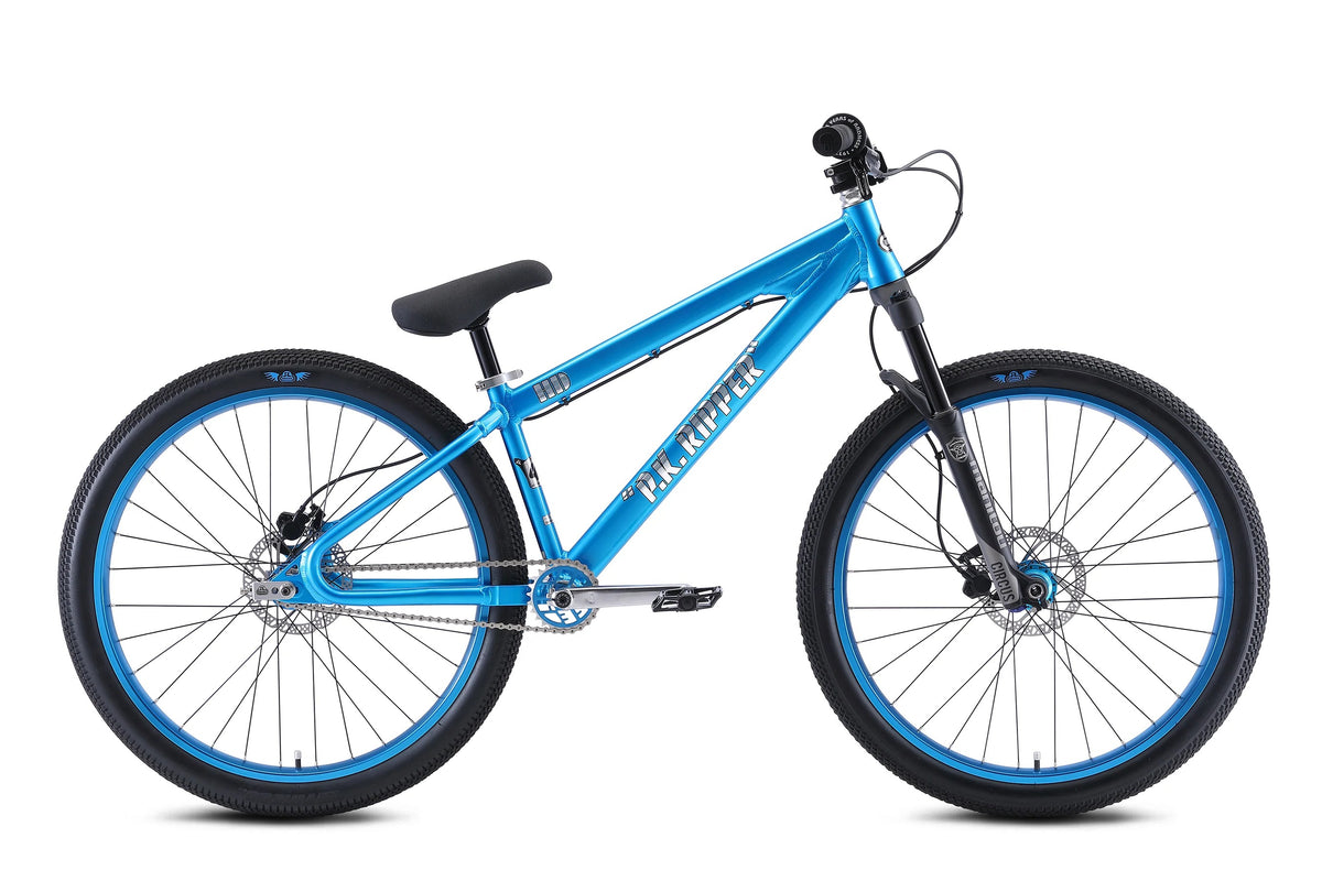 Metallic blue Dirt Jump Bicycle with 'P.K. Ripper' printed on the down tube with blue rims on a white background