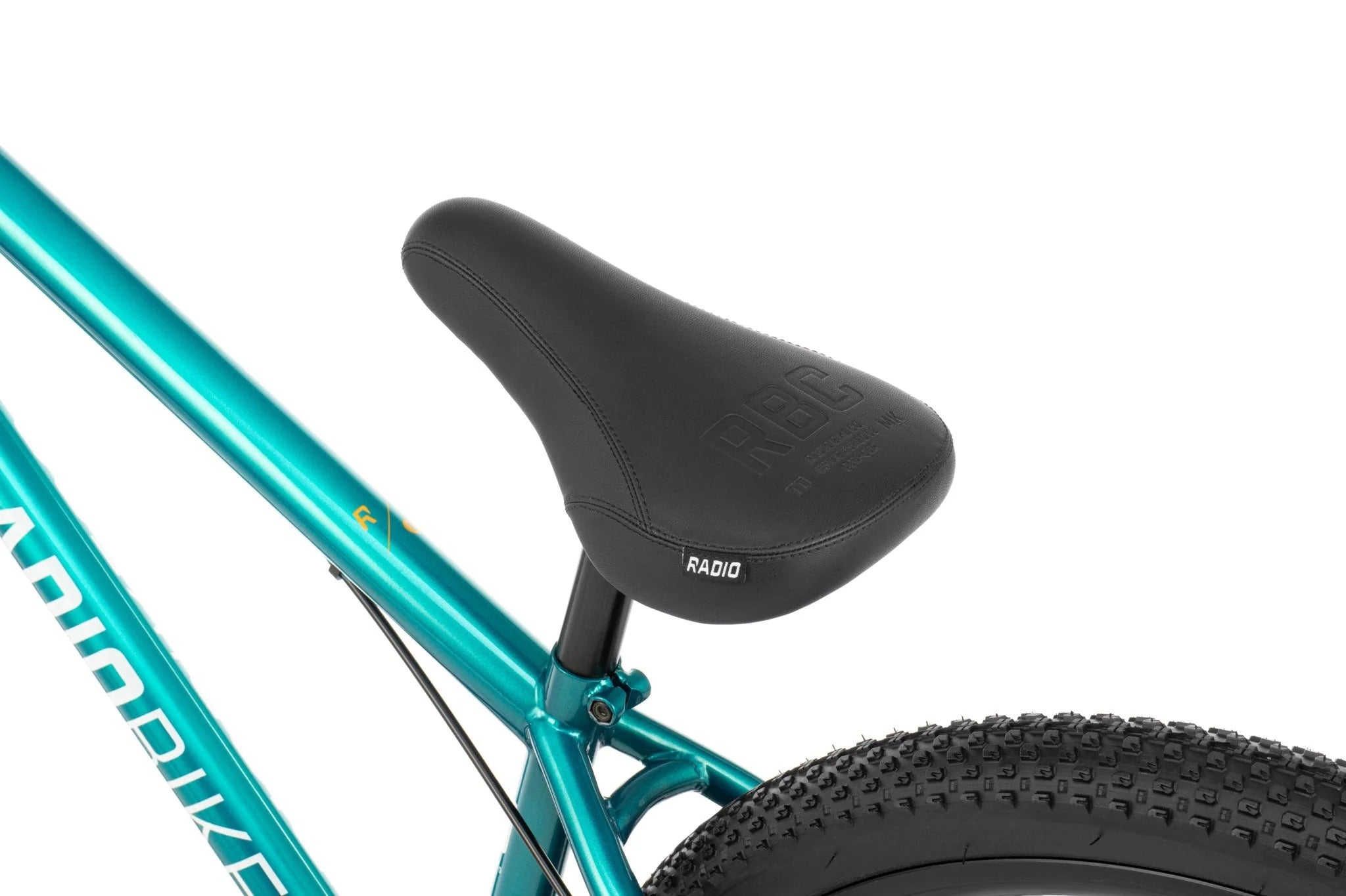 Close-up of a turquoise blue dirt jumper bicycle frame with a black seat on a white background