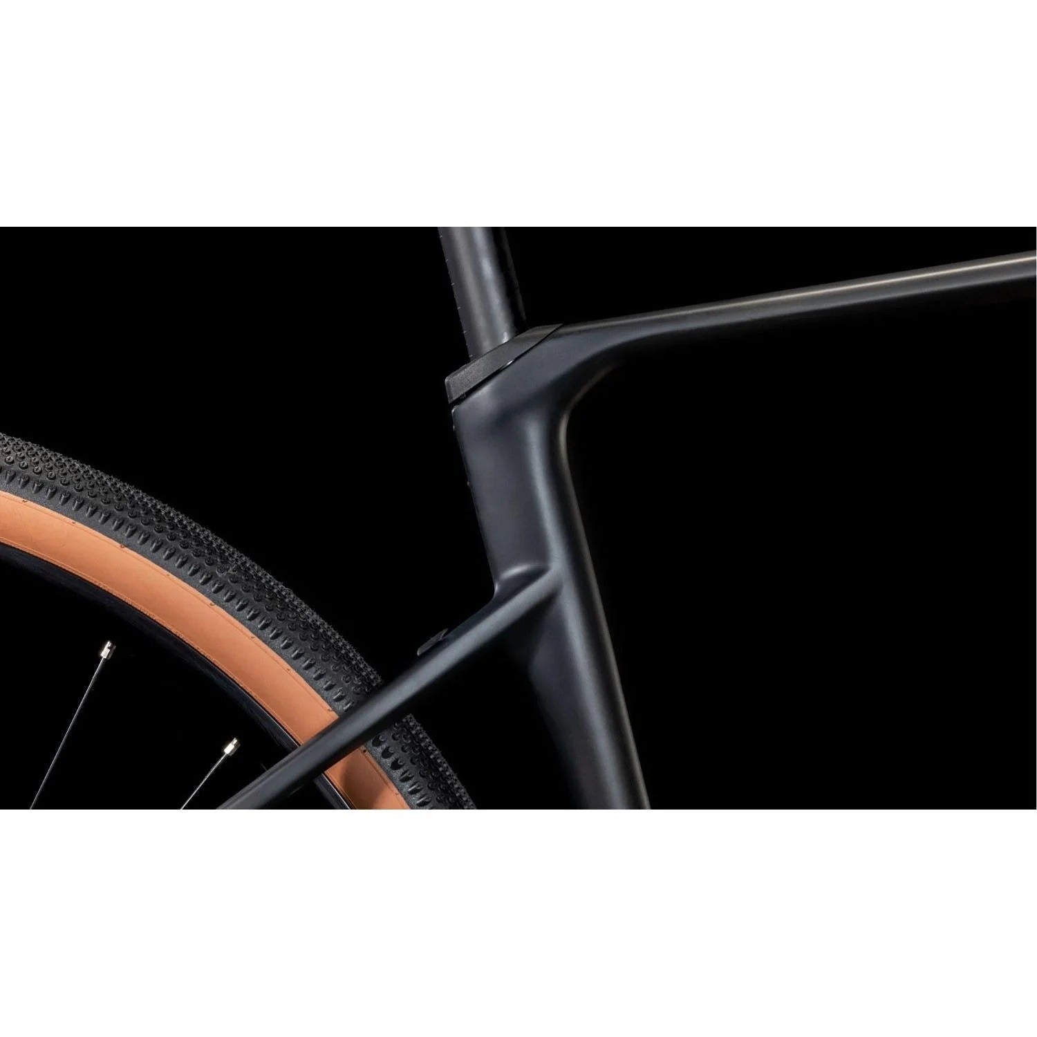 Close-up of a gravel bike wheel and frame on a black background