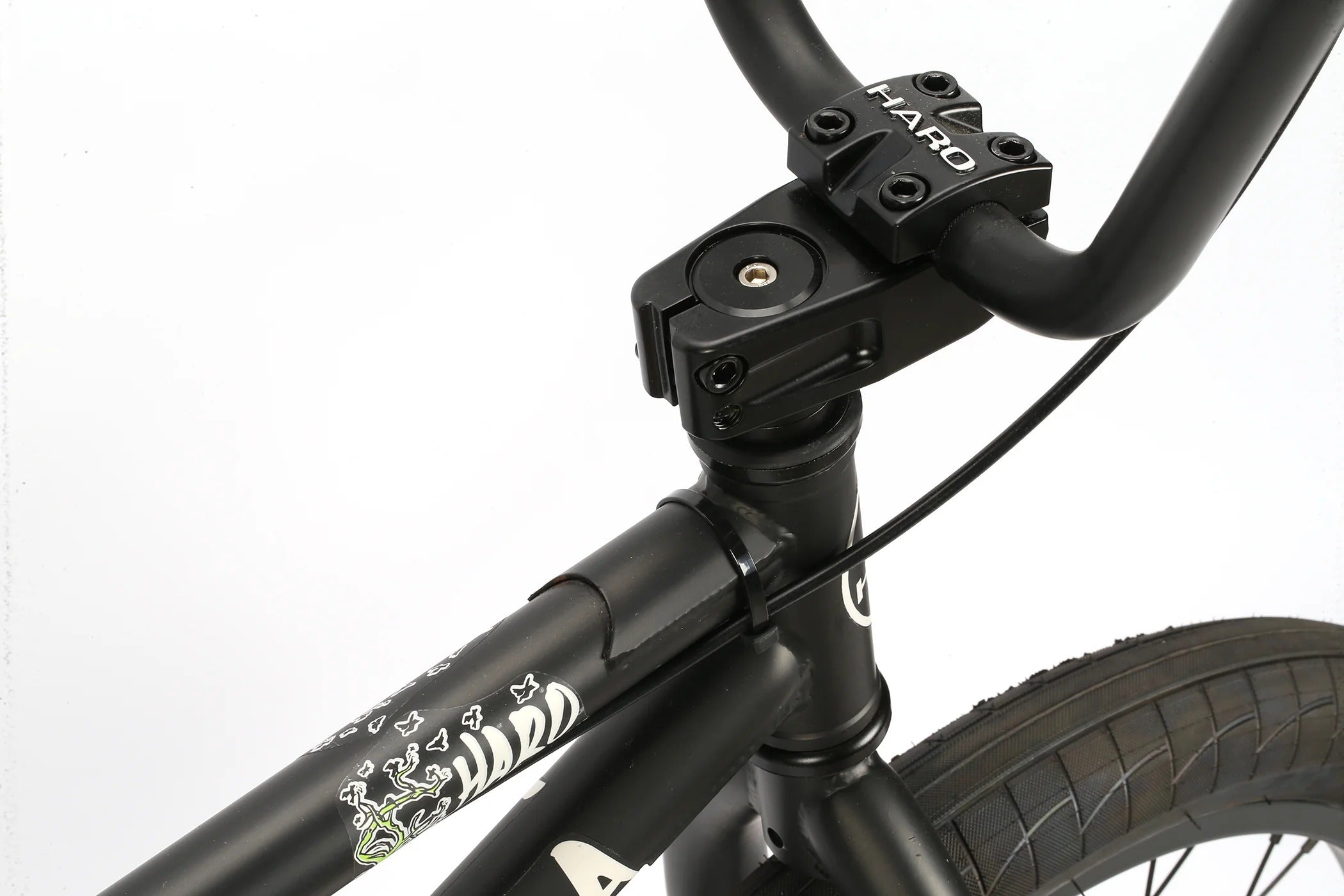 Close-up of a black Haro BMX bicycle frame with visible branding on a white background