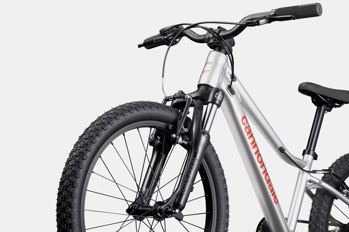 A silver Cannondale kids mountain bike on a white background